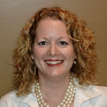 Photo of white woman with blonde hair, smiling